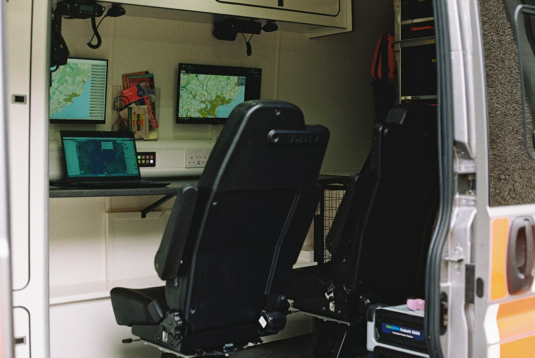 Broadcast control room with rows of monitors showing multiple live camera feeds